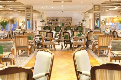 This image: Cocktail hour is held in the luxurious Salon du Grand Trianon each evening on board the SS Antoinette