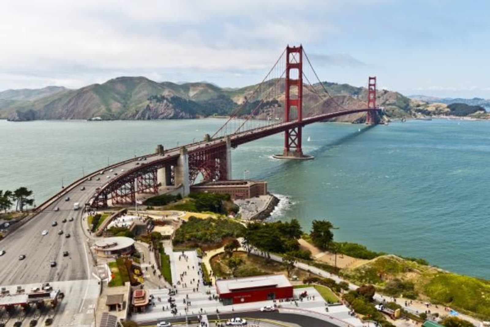Cars entering and exiting Golden Gate Bridge during day time