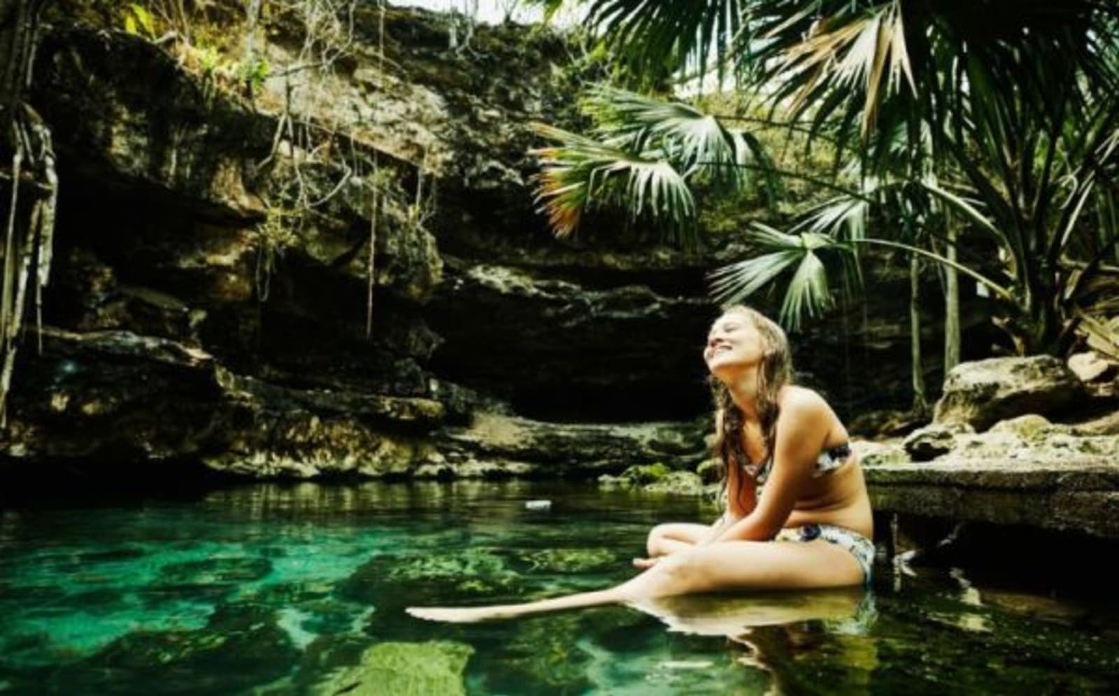 woman sitting in natural pool