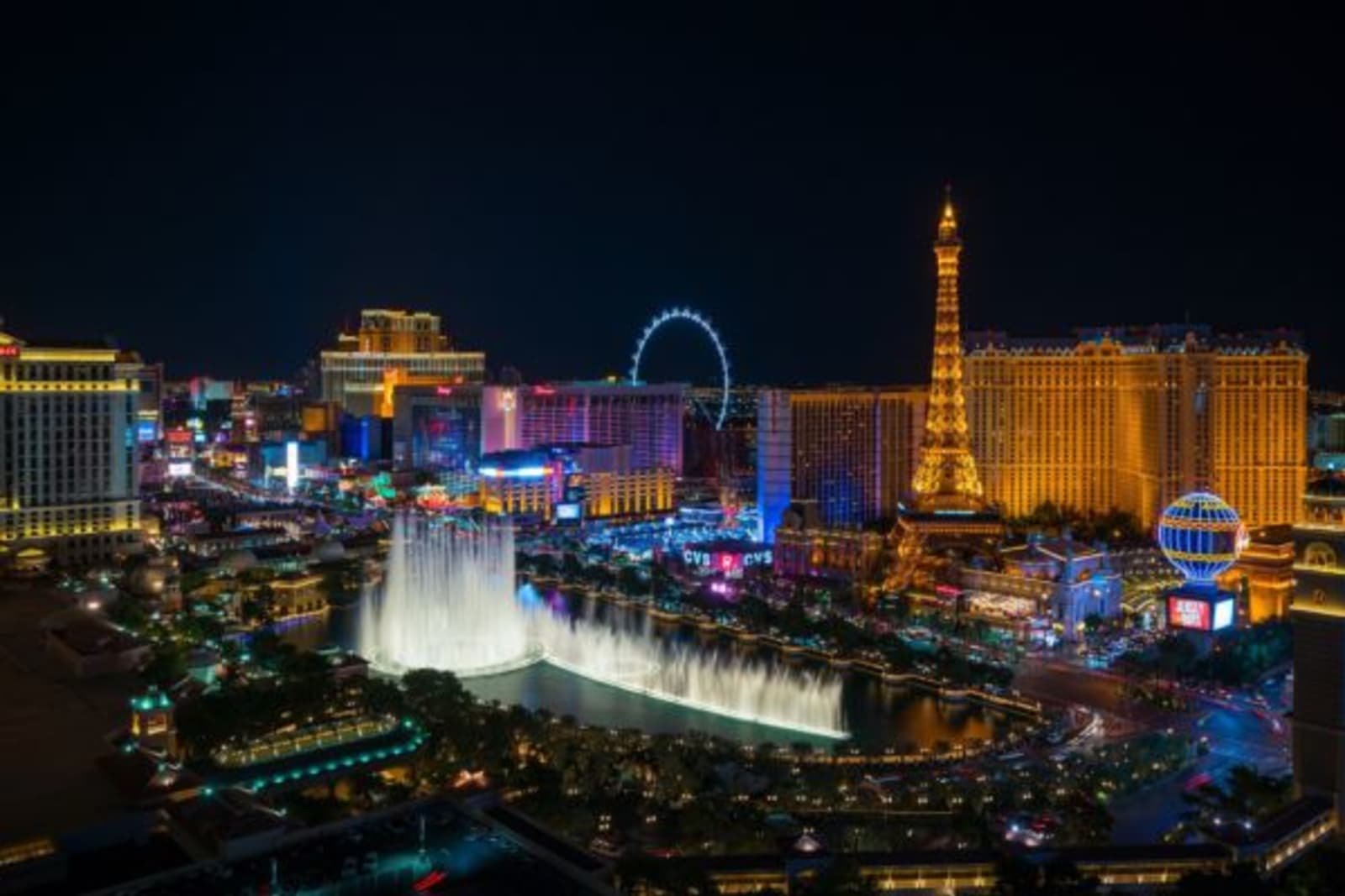 Las Vegas Strip lite up at night with water blasting up from fountain