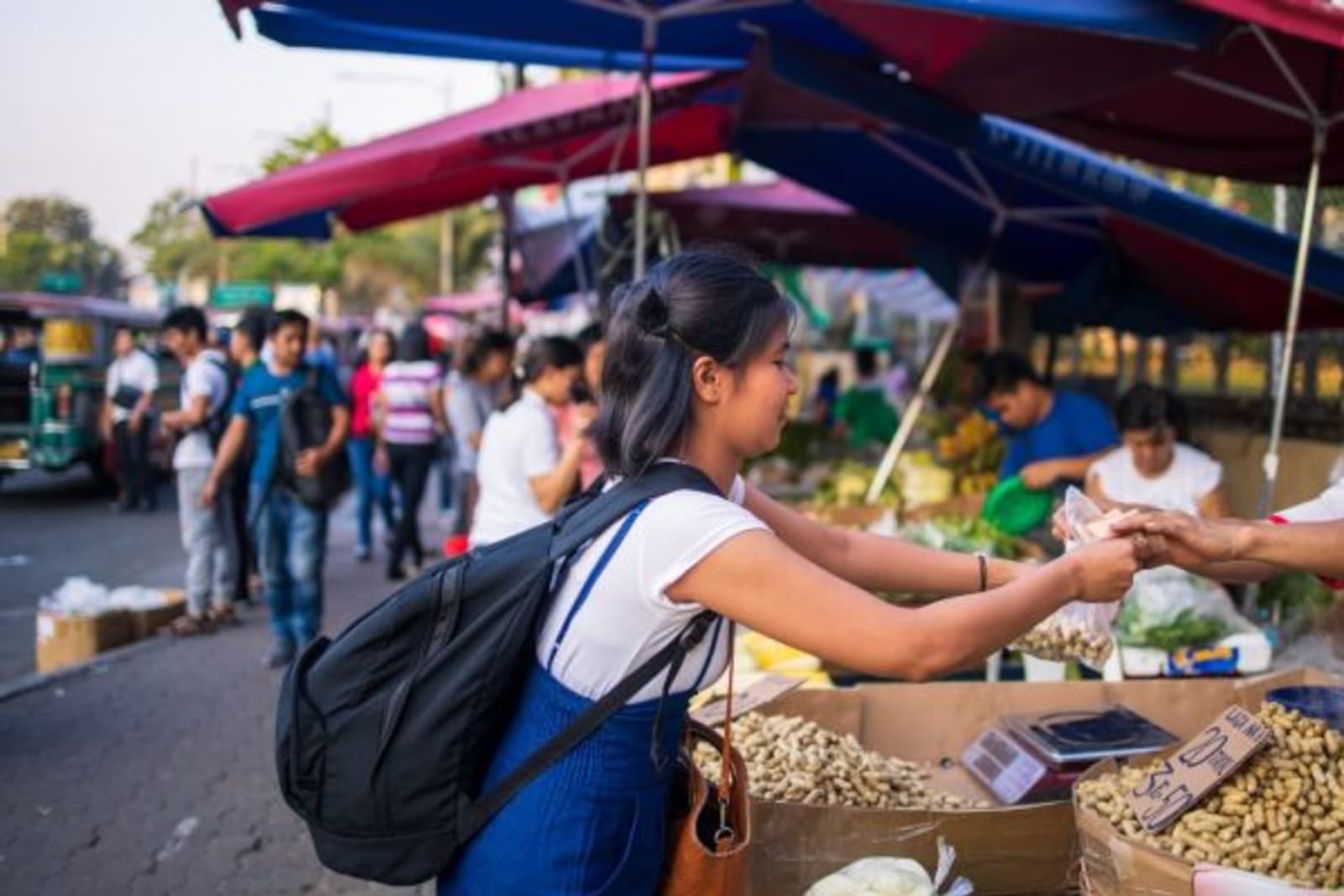 Woman buying nuts at a street food market