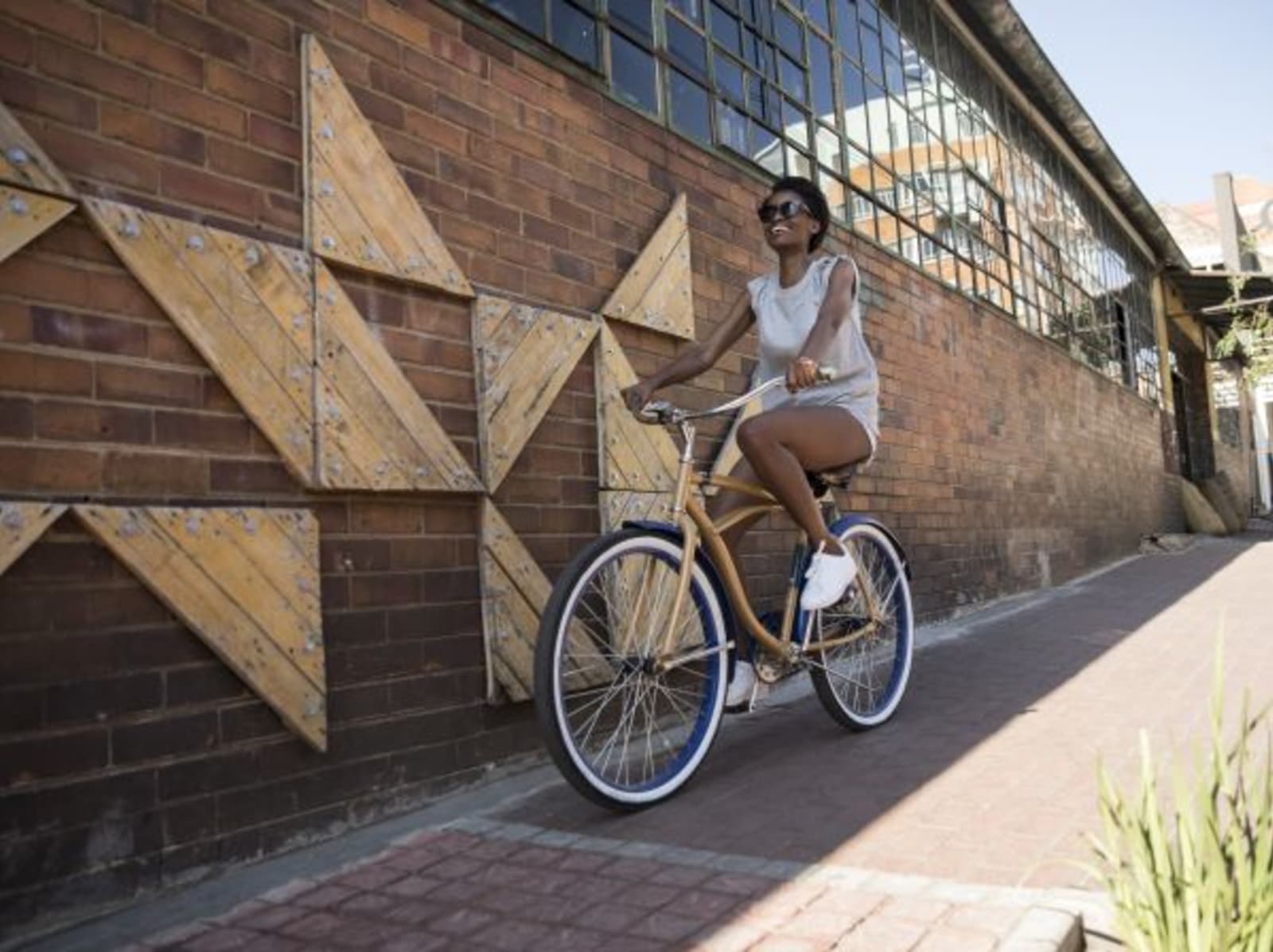 woman riding bike on paved footpath