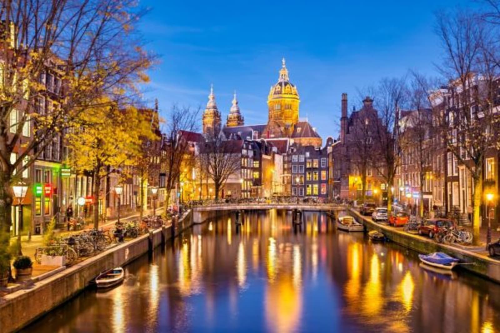 Amsterdam Canals lite up with street and building lights, reflecting in the water