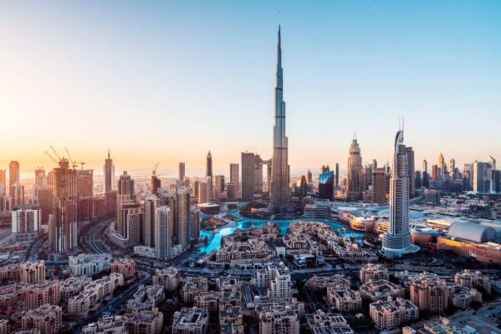Aerial view of the city of Dubai with sun rising in the horizon