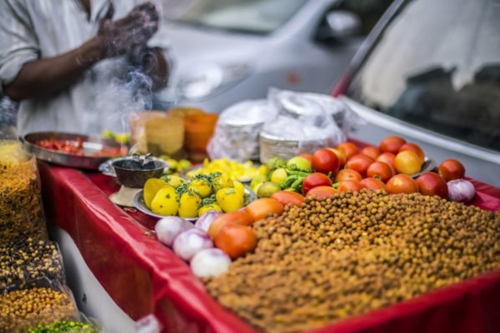Colourful spices and tomatoes laid out for street markets