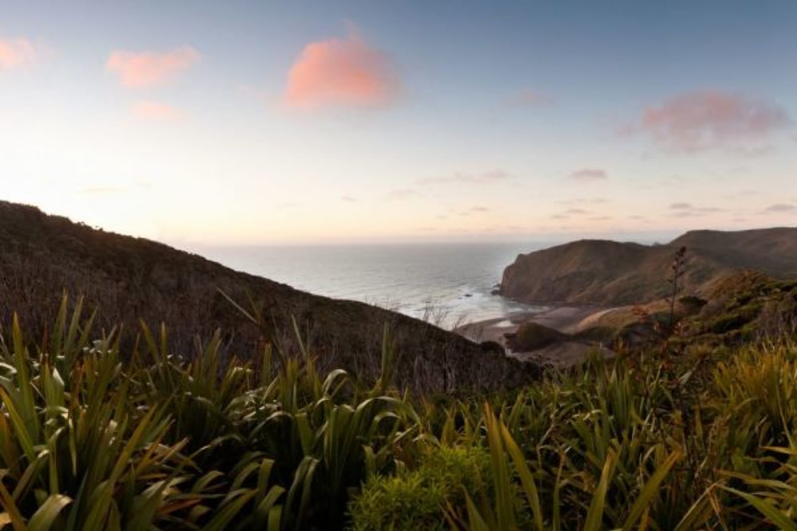 Mountain range over looking ocean at sunset