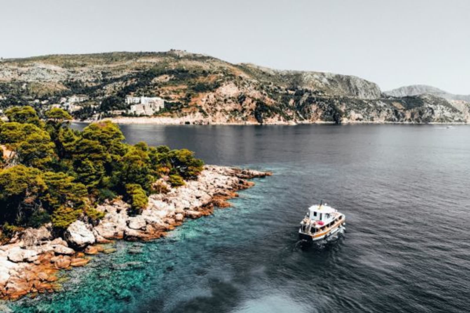 Boat sailing past shoreline