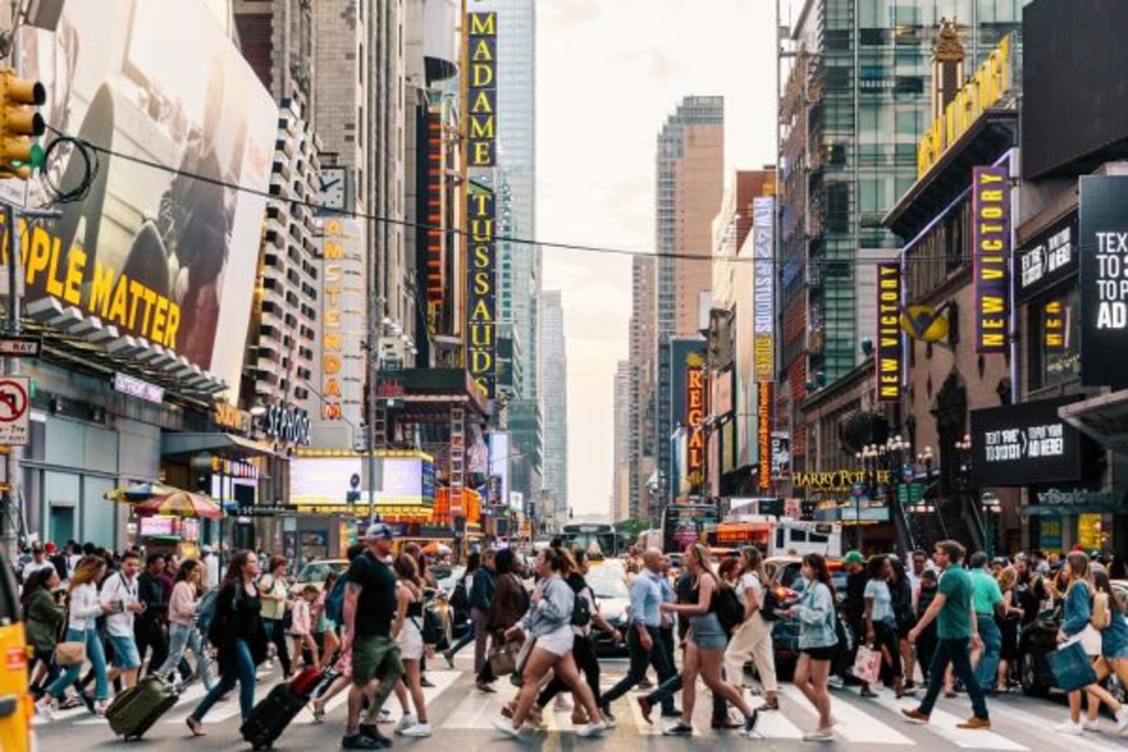 Crowd of people crossing a cross walk in Time Square