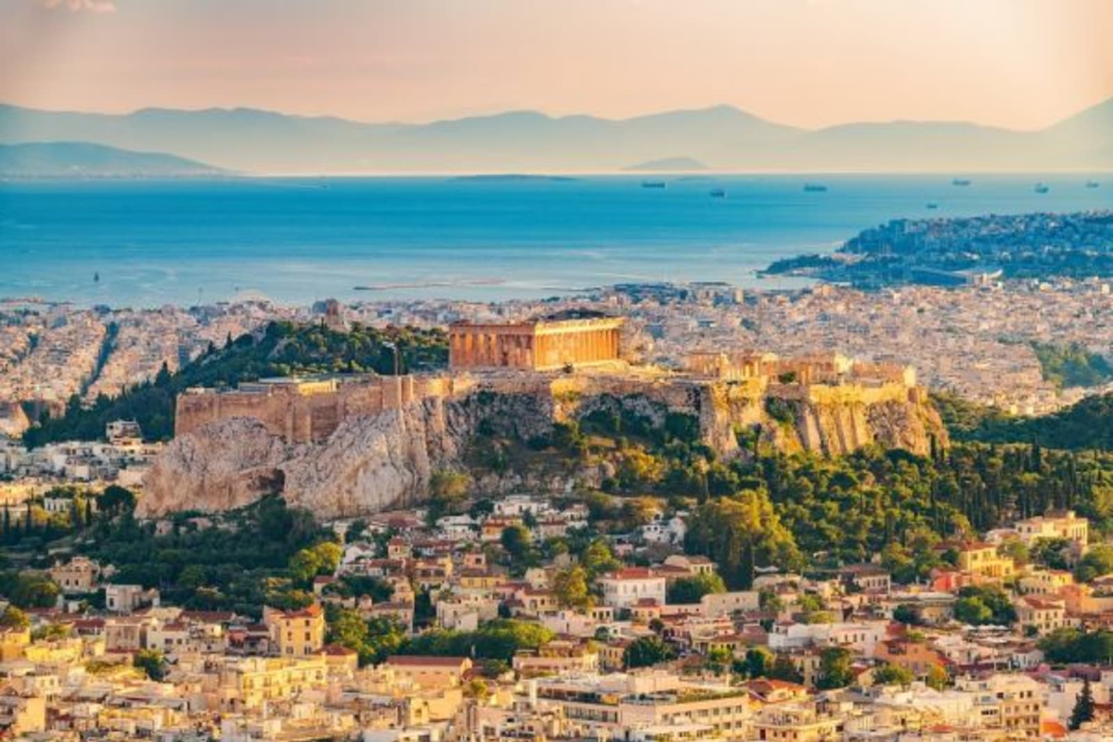 Athens at sunset over looking the town and ocean in background