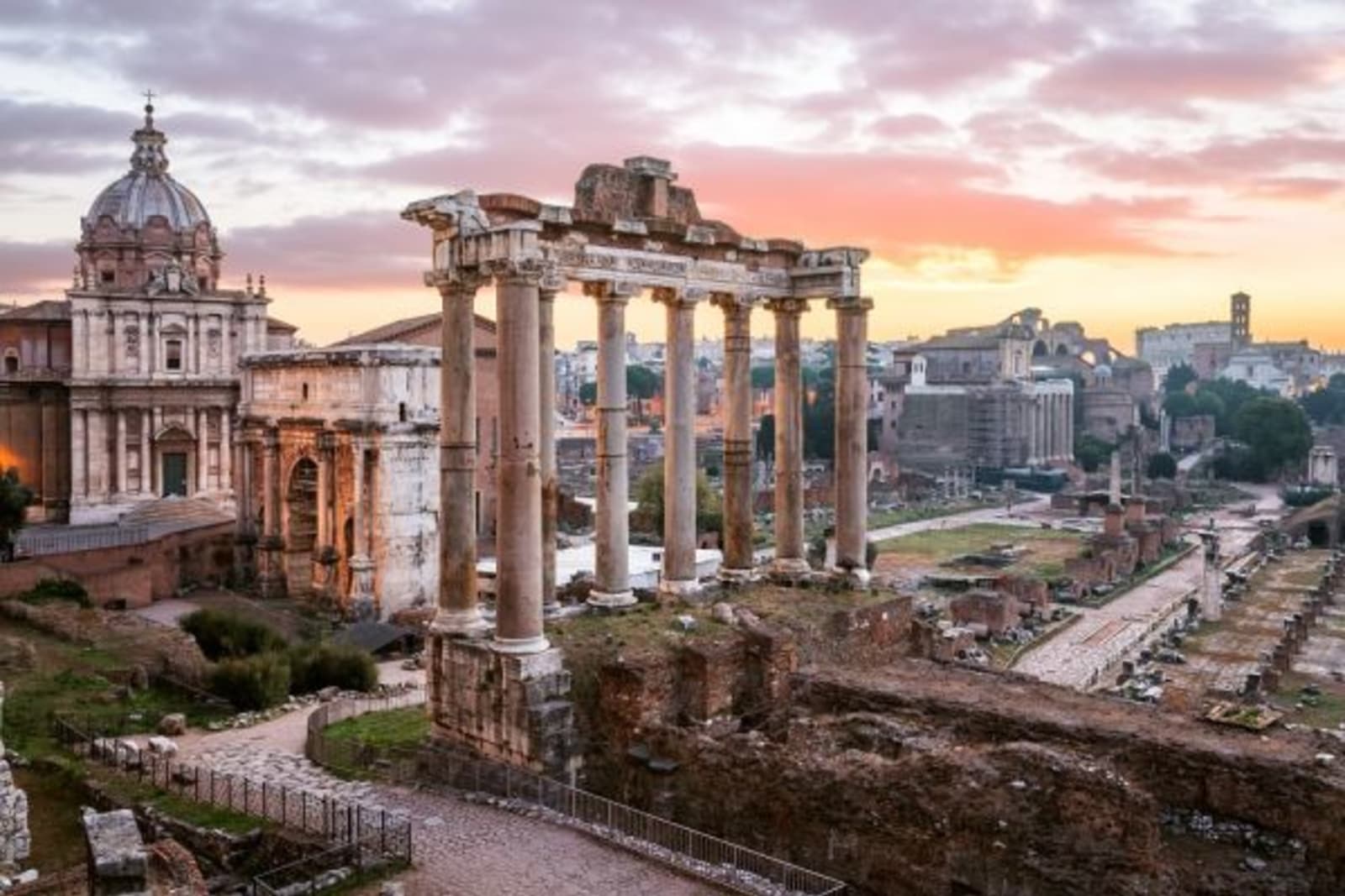 Ancient roman ruins with sun setting in background