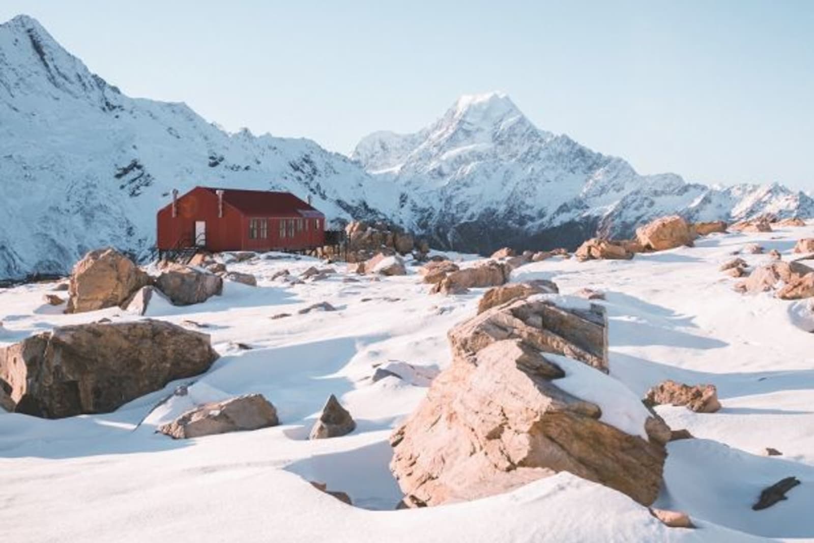 Small red shed on snowy mountain top