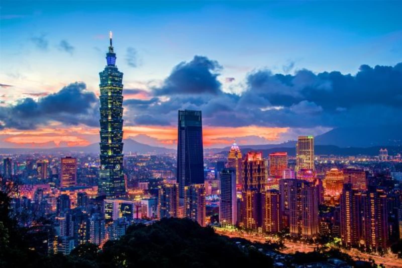 Distant view of a lite up city at dusk
