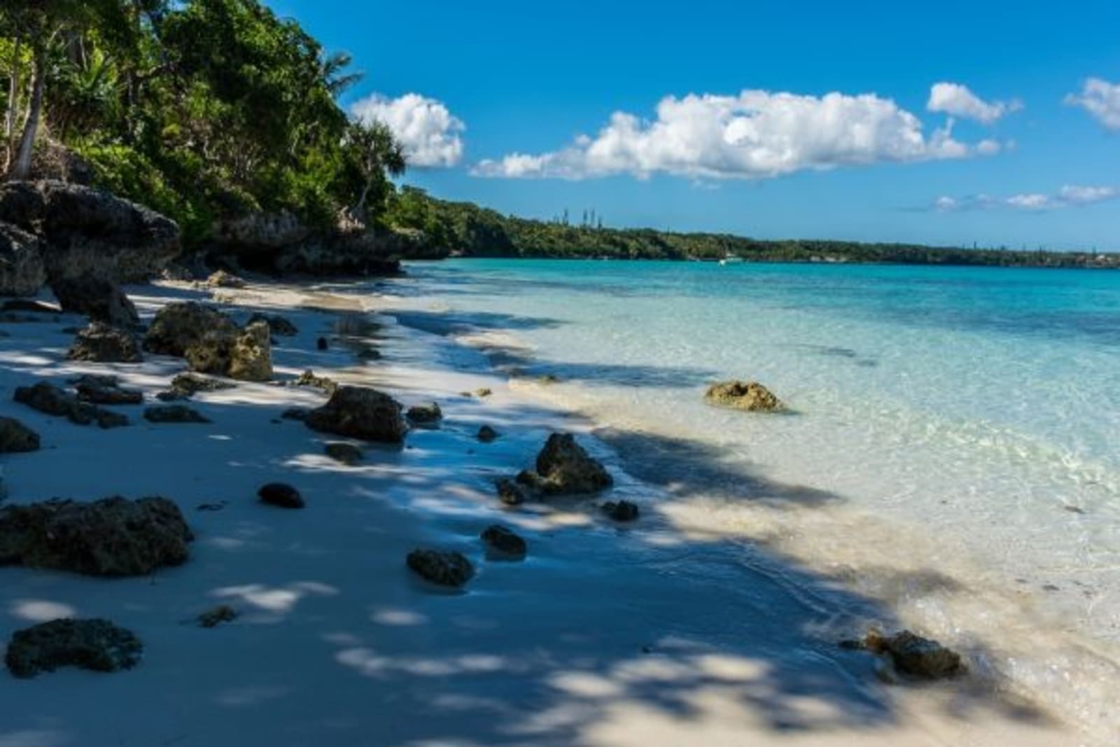 Beach front with rocks coming out of the sand