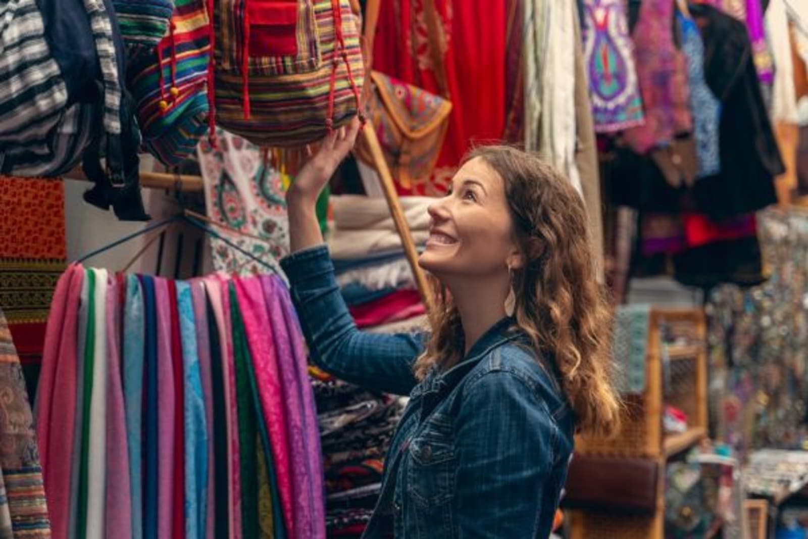 Female looking at colourful materials at a market