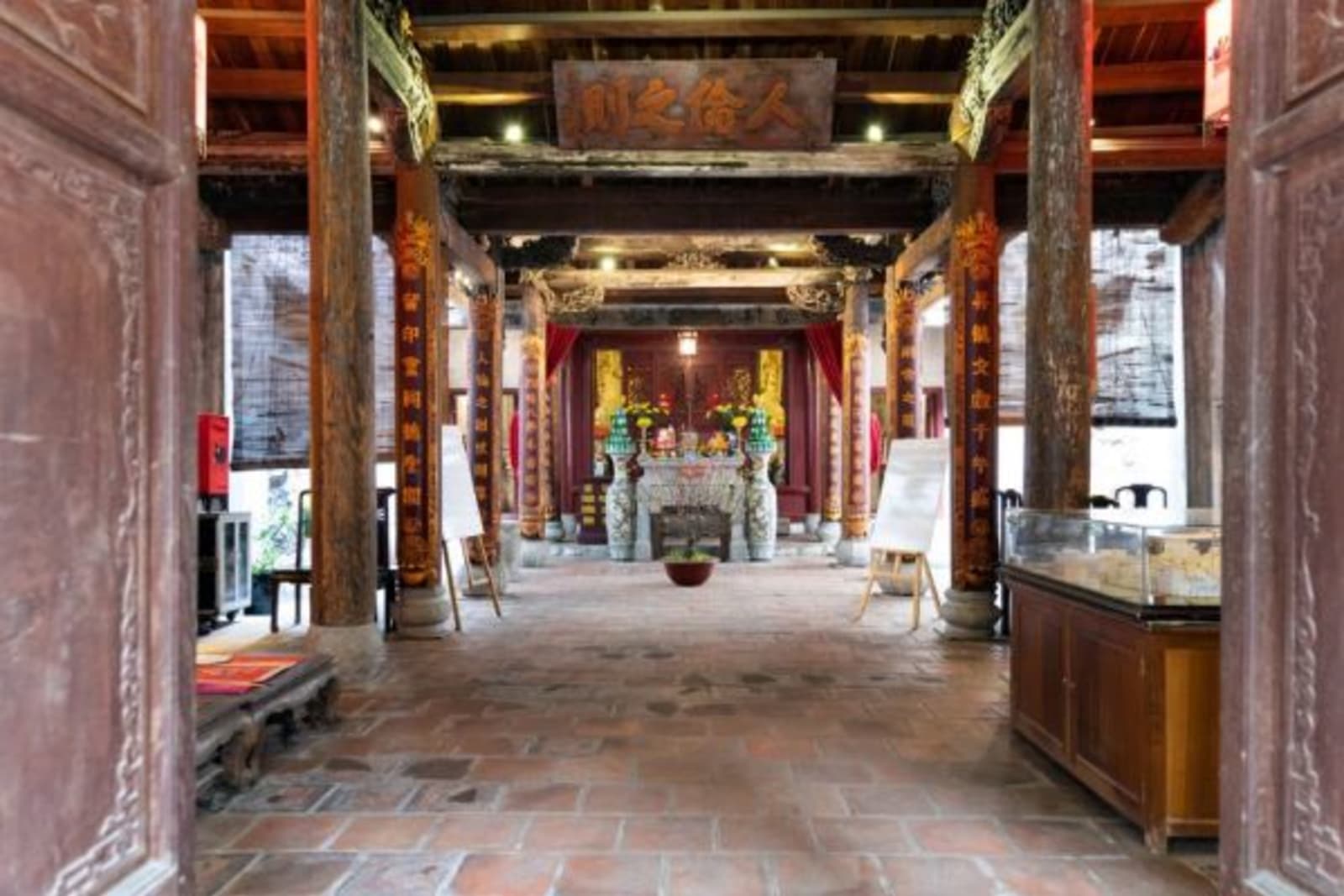 Interior hallway of a temple leading to prayer area against back wall