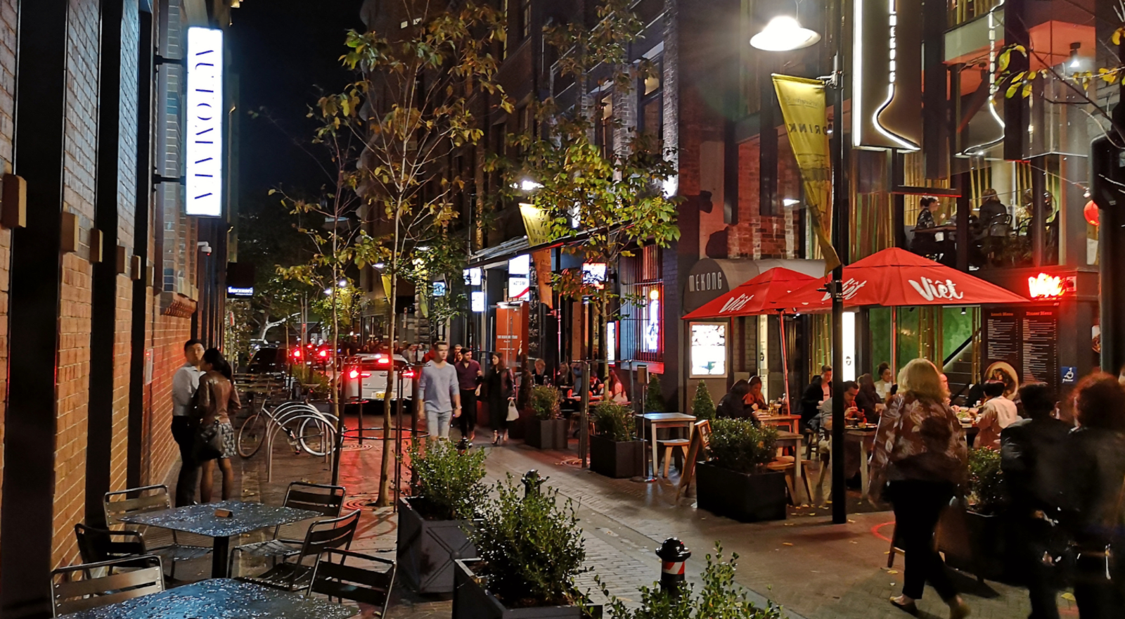 Busy street in Sydney with restaurants at night
