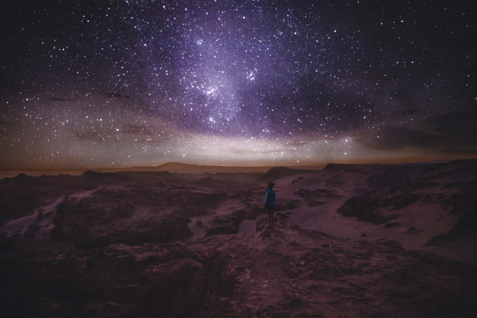 Woman stargazing under the night sky in Atacama Desert in Chile