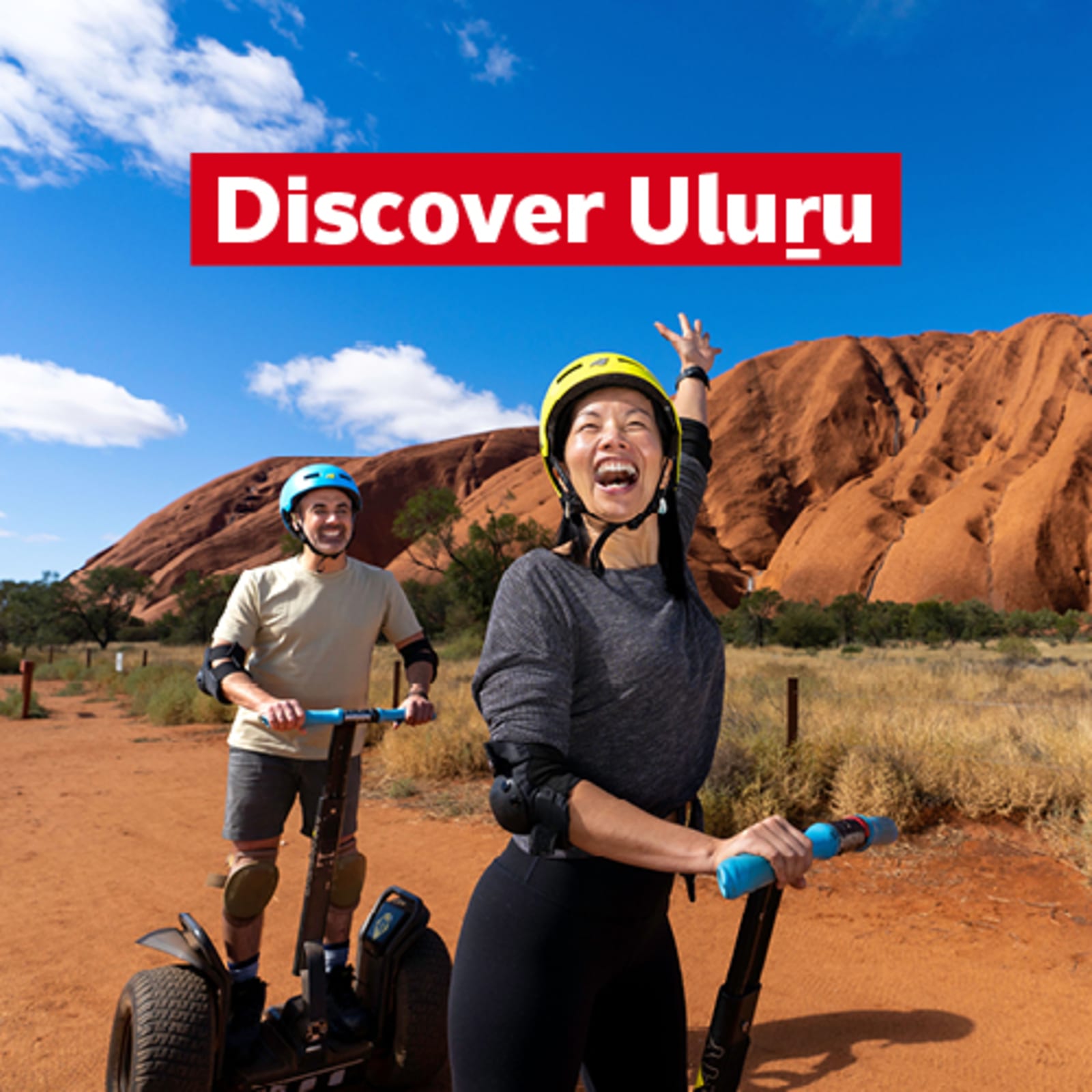 Discover Uluru - two people smiling on Segways touring Uluru