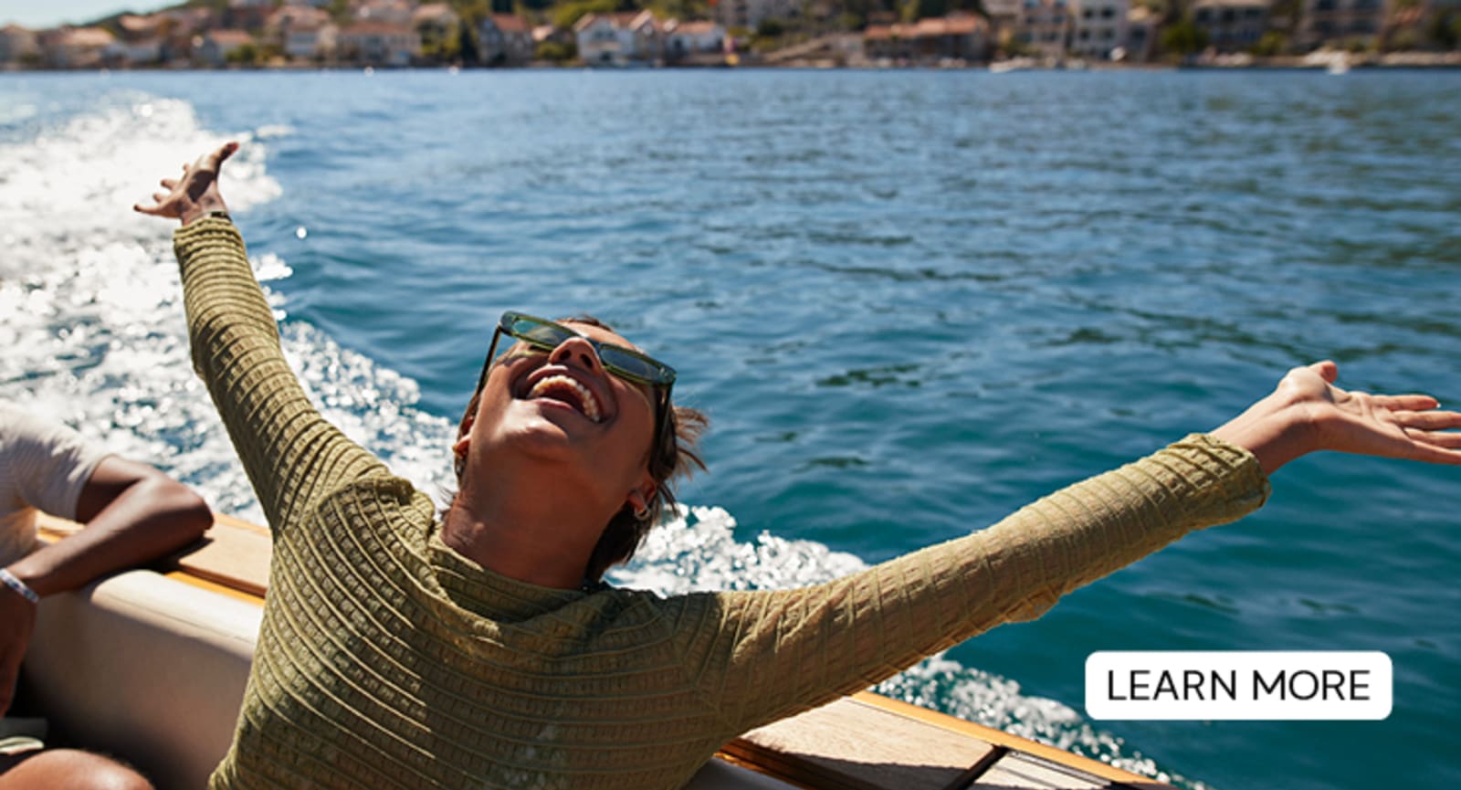 Woman with her arms outstretched on a boat
