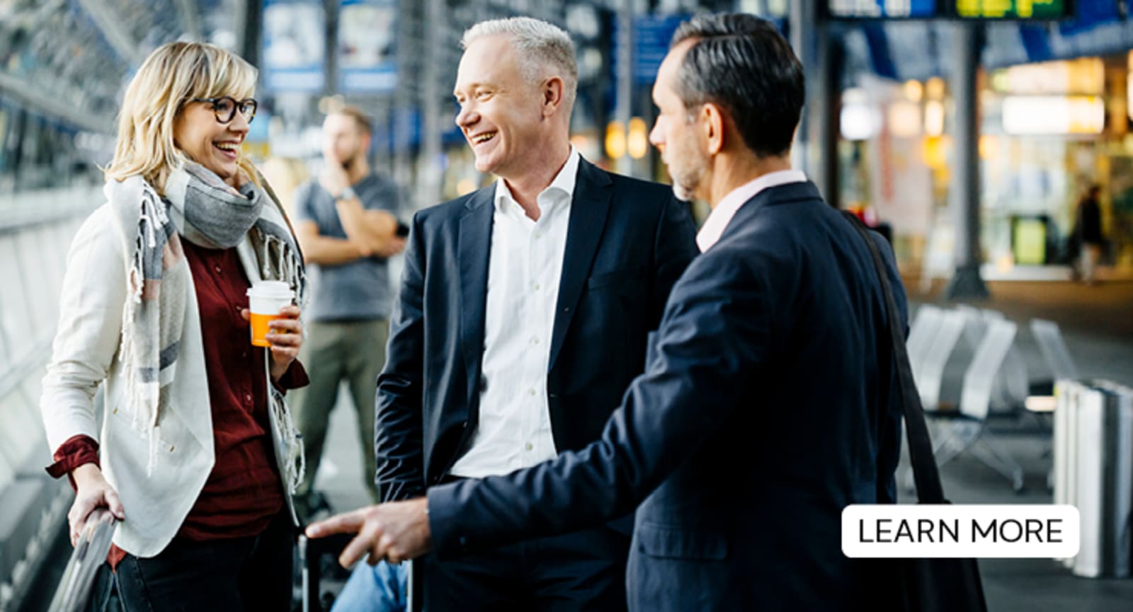 Elderly businesspeople laughing and chatting over coffee