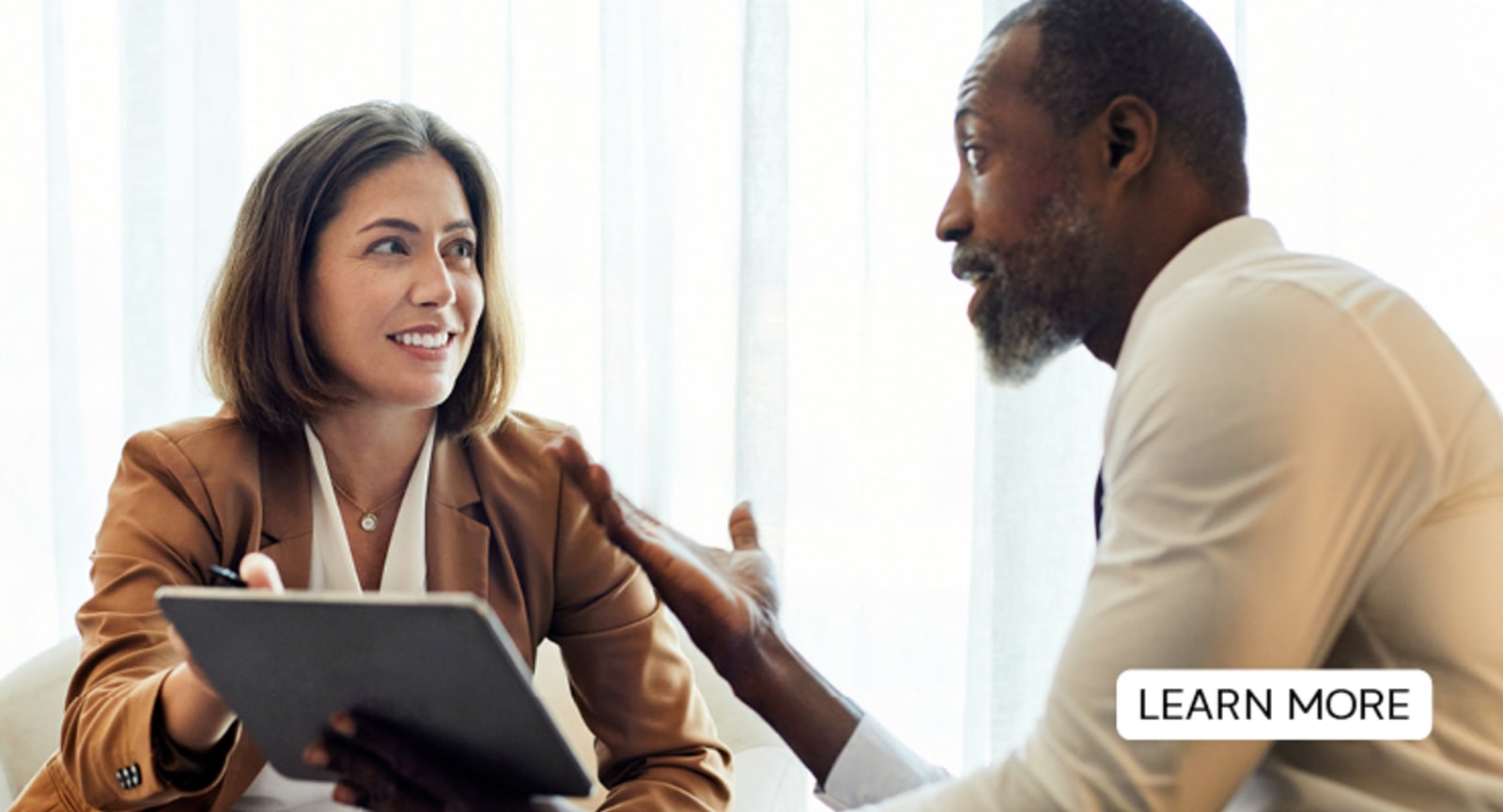 Businesspeople having a discussion over a tablet