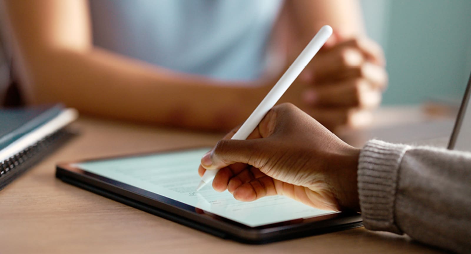 Closeup of a hand drawing on a tablet