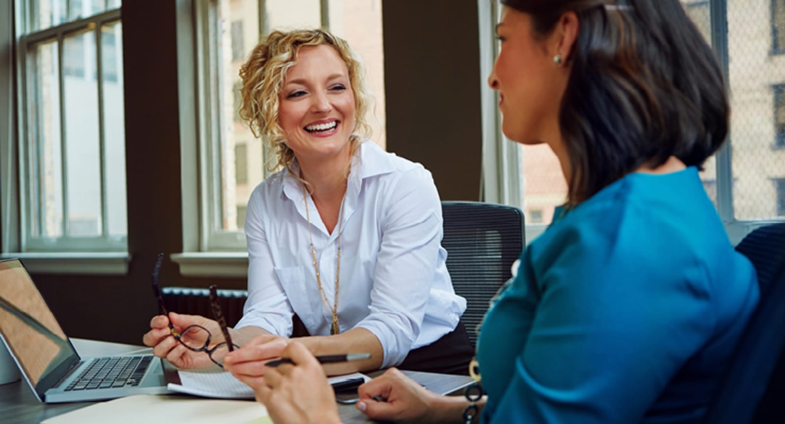 Two businesswomen chatting in an office