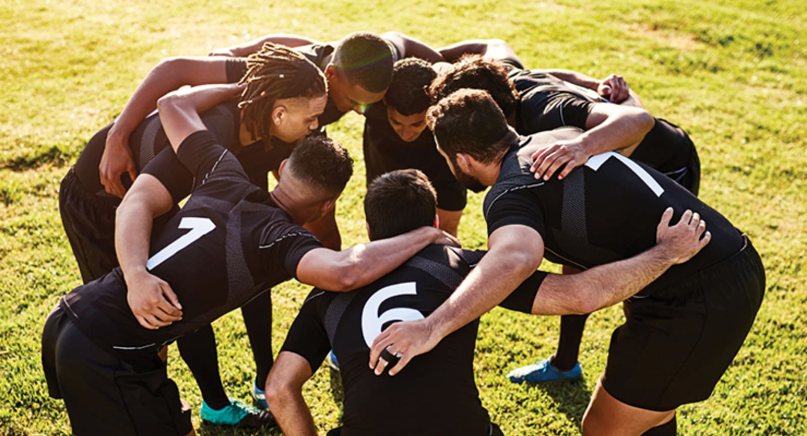 Group of Rugby players in a huddle