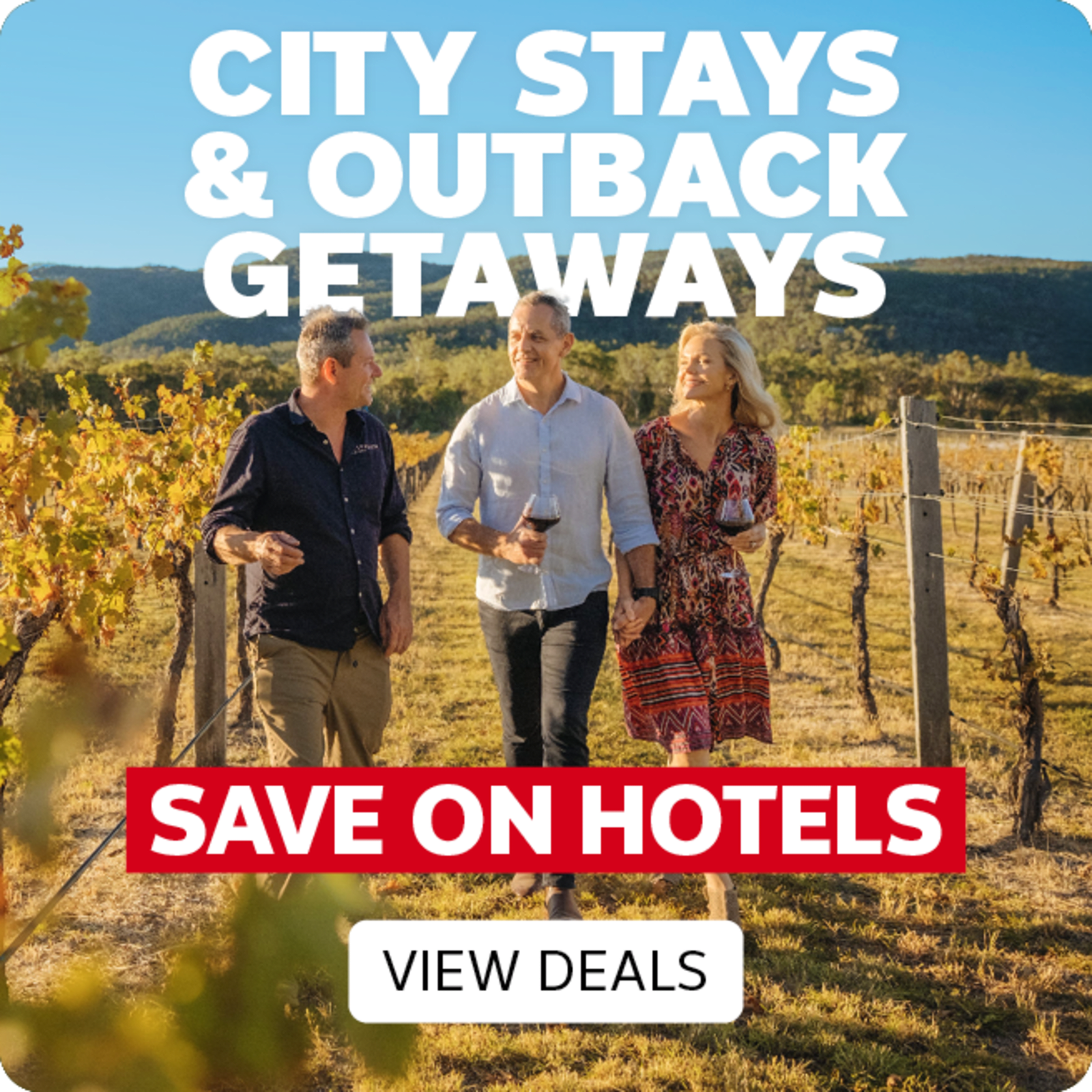 Three people drinking wine walking through a wine vineyard, featuring City Stays & Outback Getaways