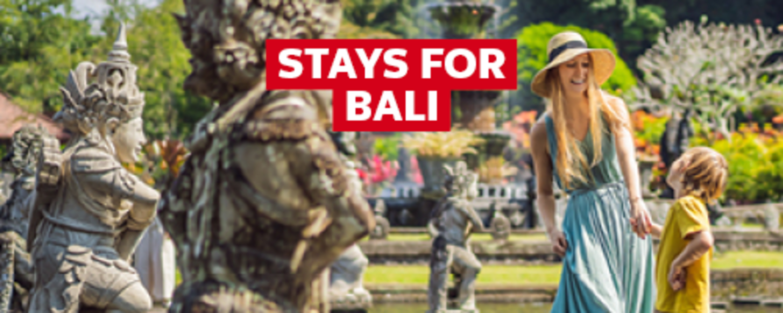 stays for Bali - Mother and child smiling, standing next to a series of statues in Bali