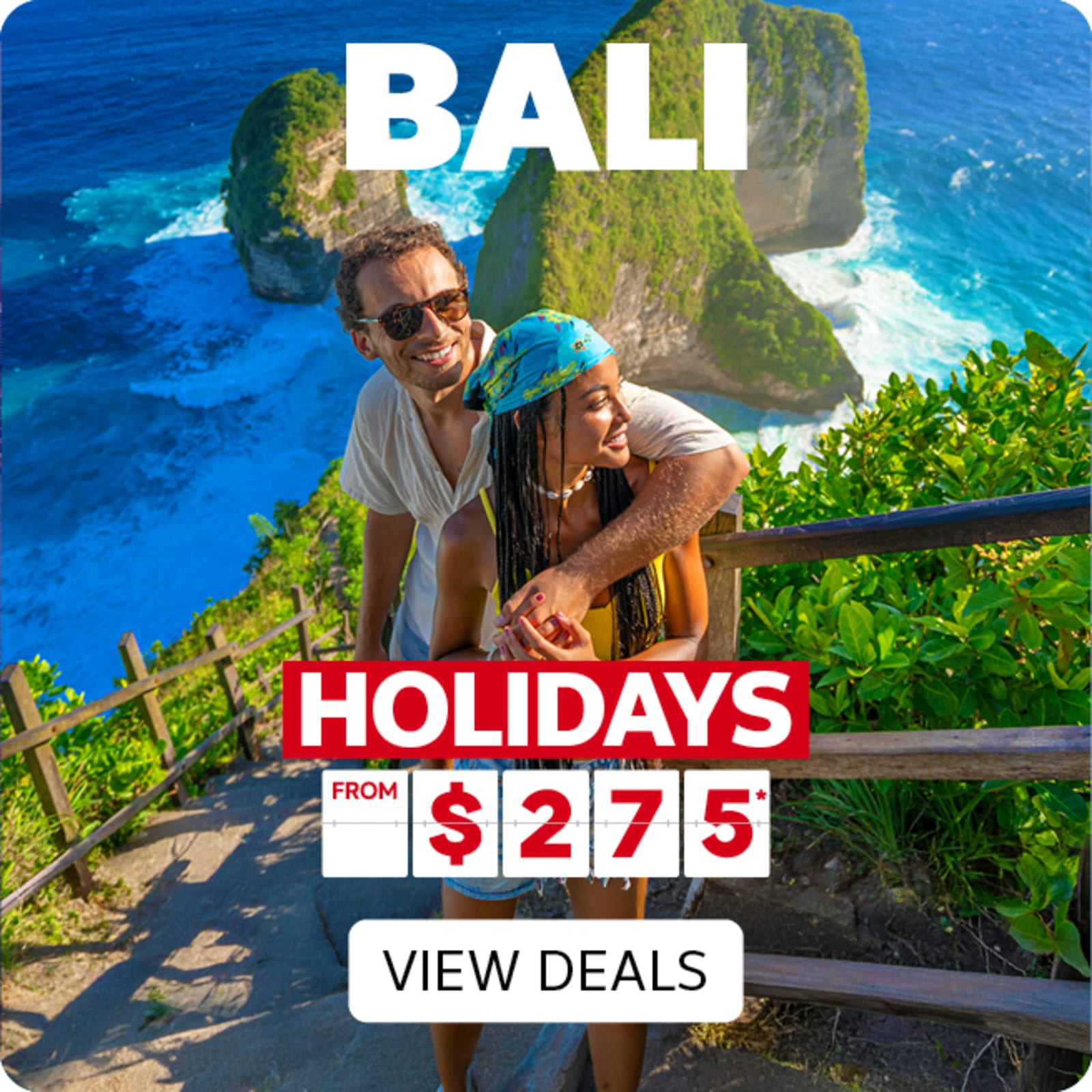 Couple embracing on a cliffside lookout above Bali's turquoise waters and dramatic sea stacks featuring Bali holidays from $275