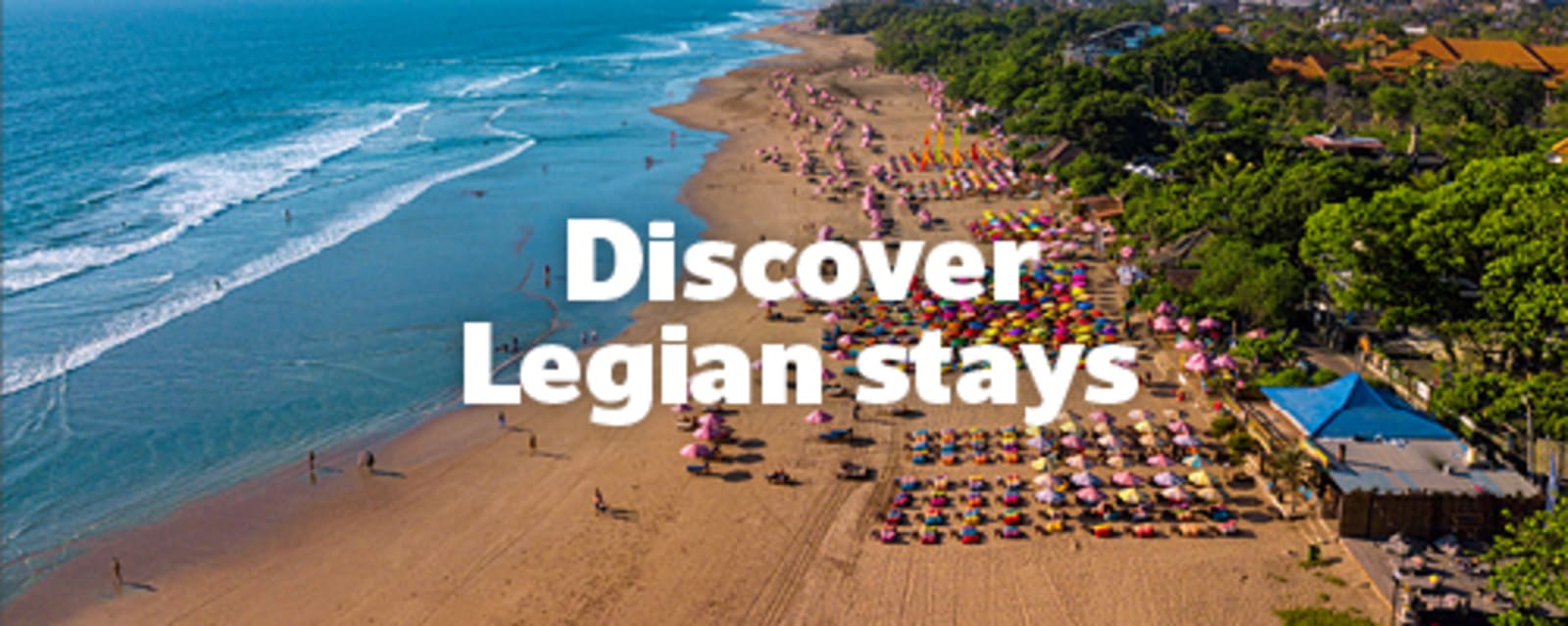 Overhead shot of hundreds of people on a beach in Legian, Indonesia