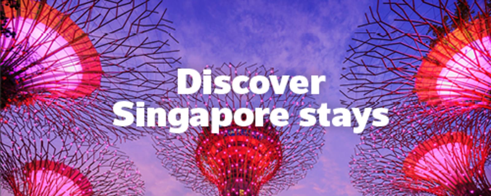 Gardens by the bay in Singapore lit by purple lights