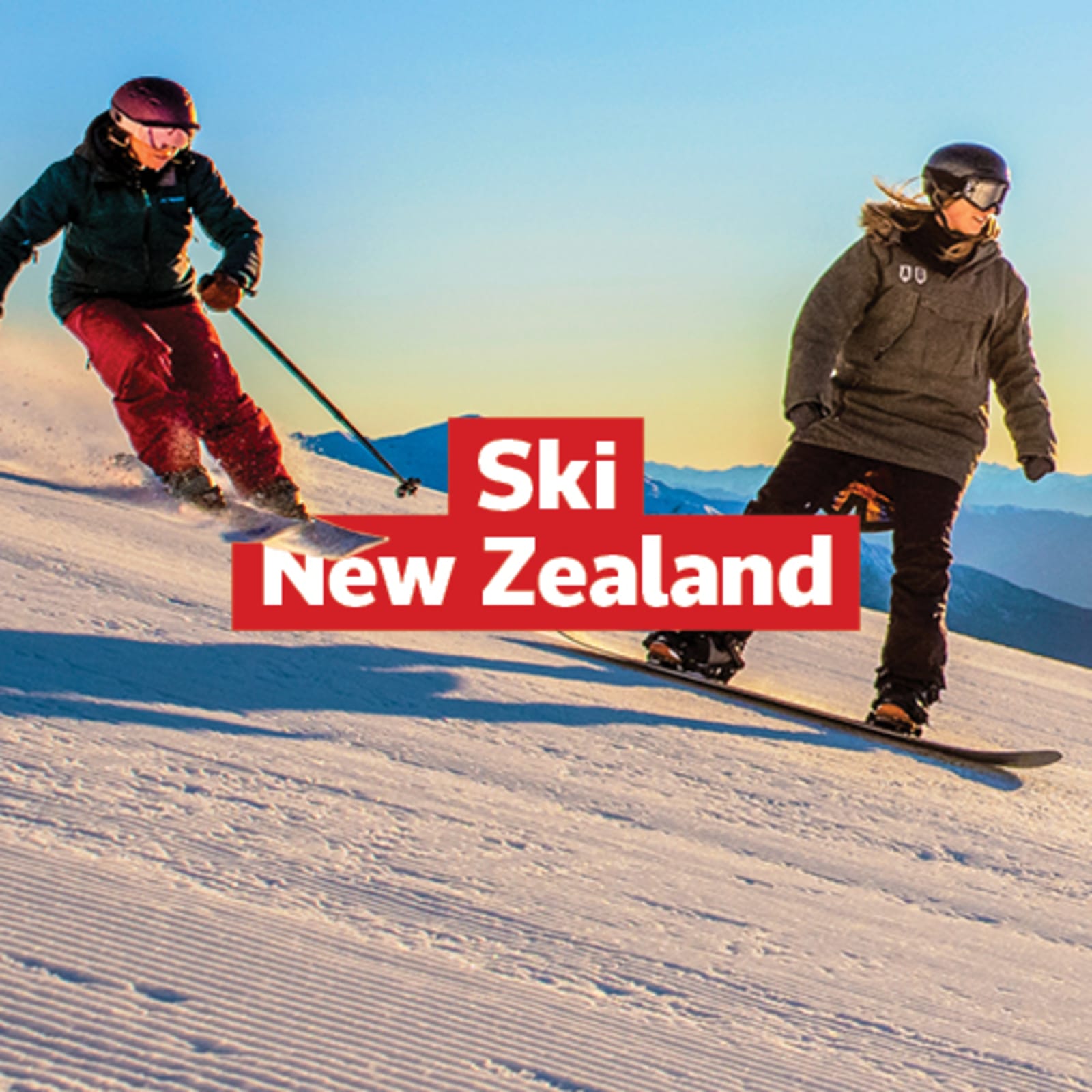 Two people skiing and snowboarding down an icy run in the early sunset