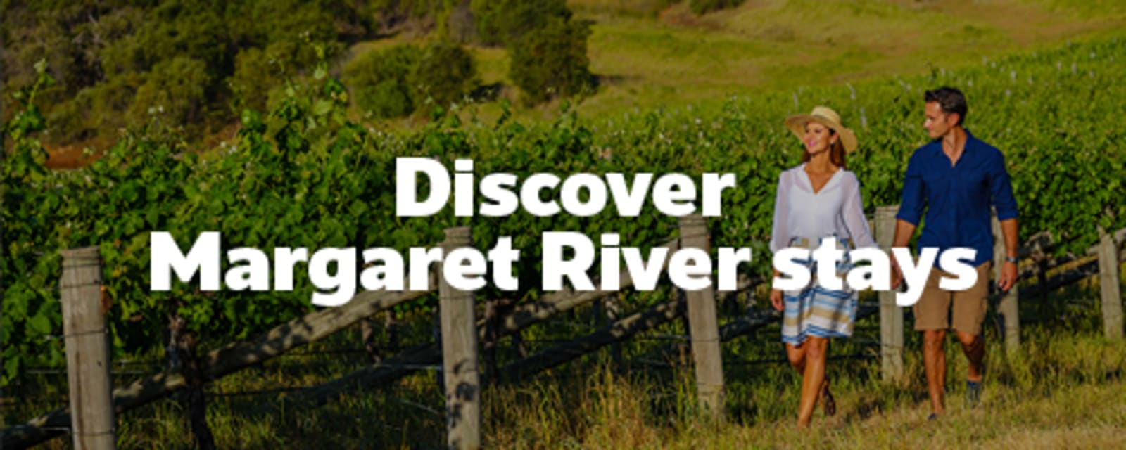 Couple walking through a wine vineyard featuring Margaret River stays