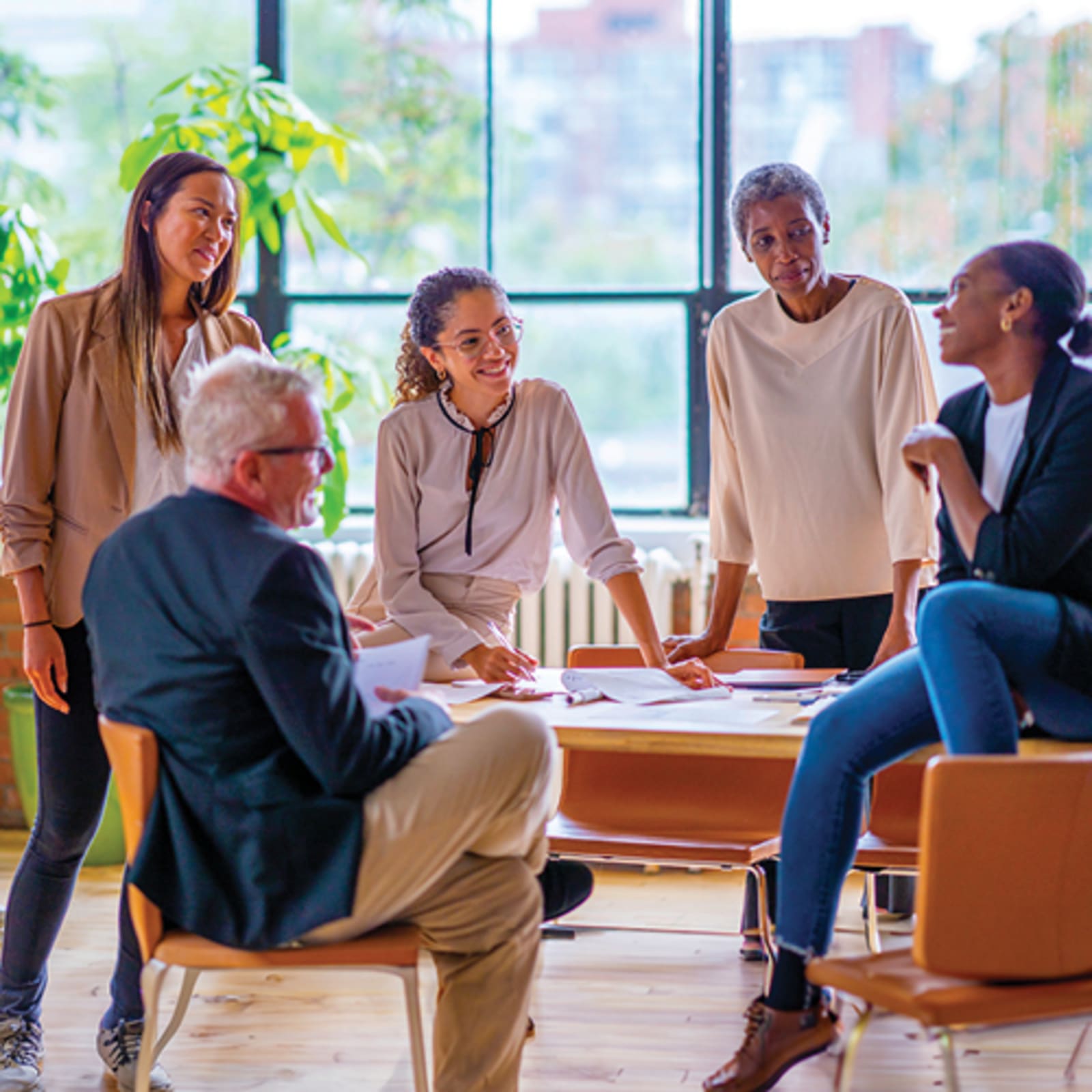 Group of people sitting around round table