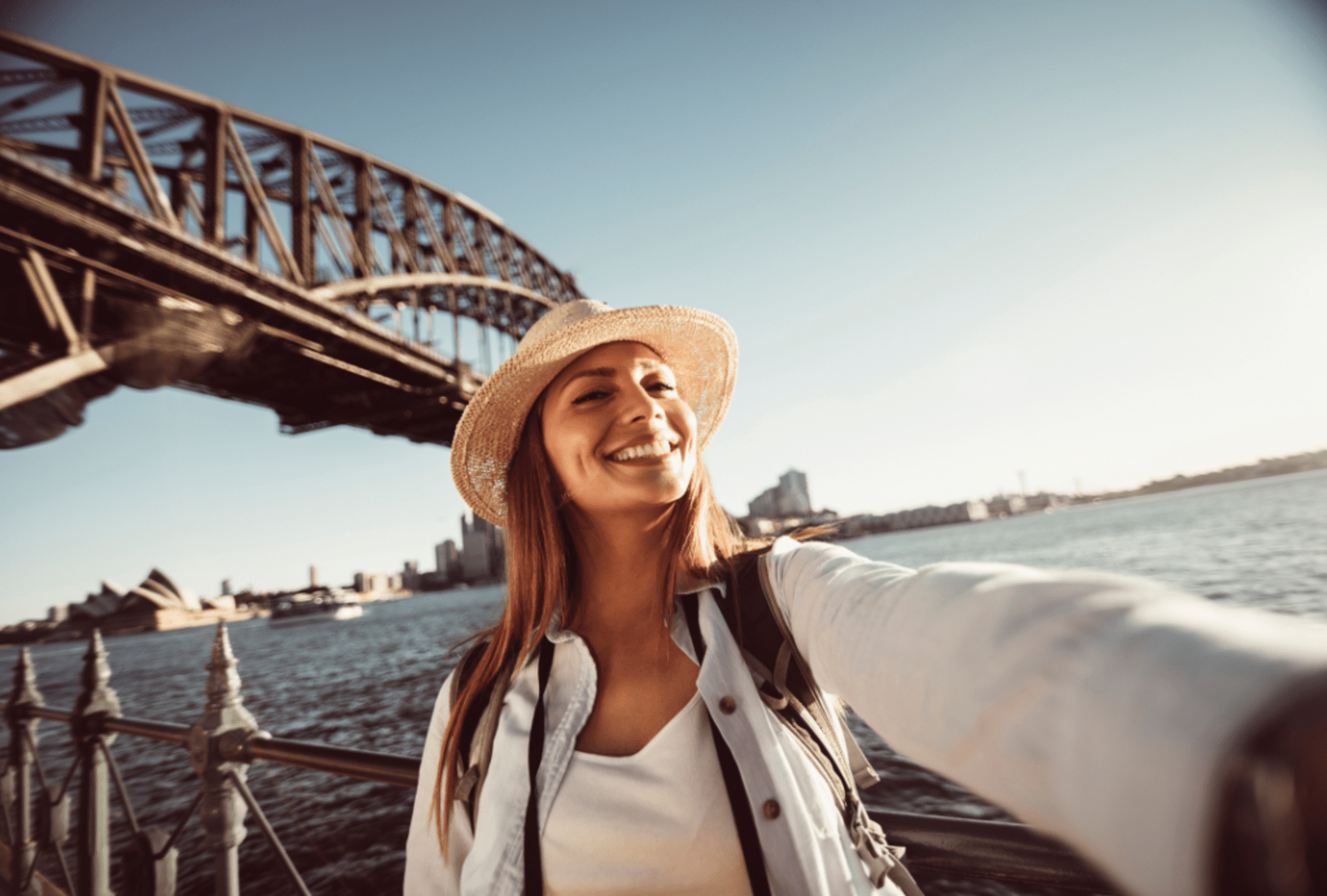 A woman takes a selfie by Sydney Harbour Bridge