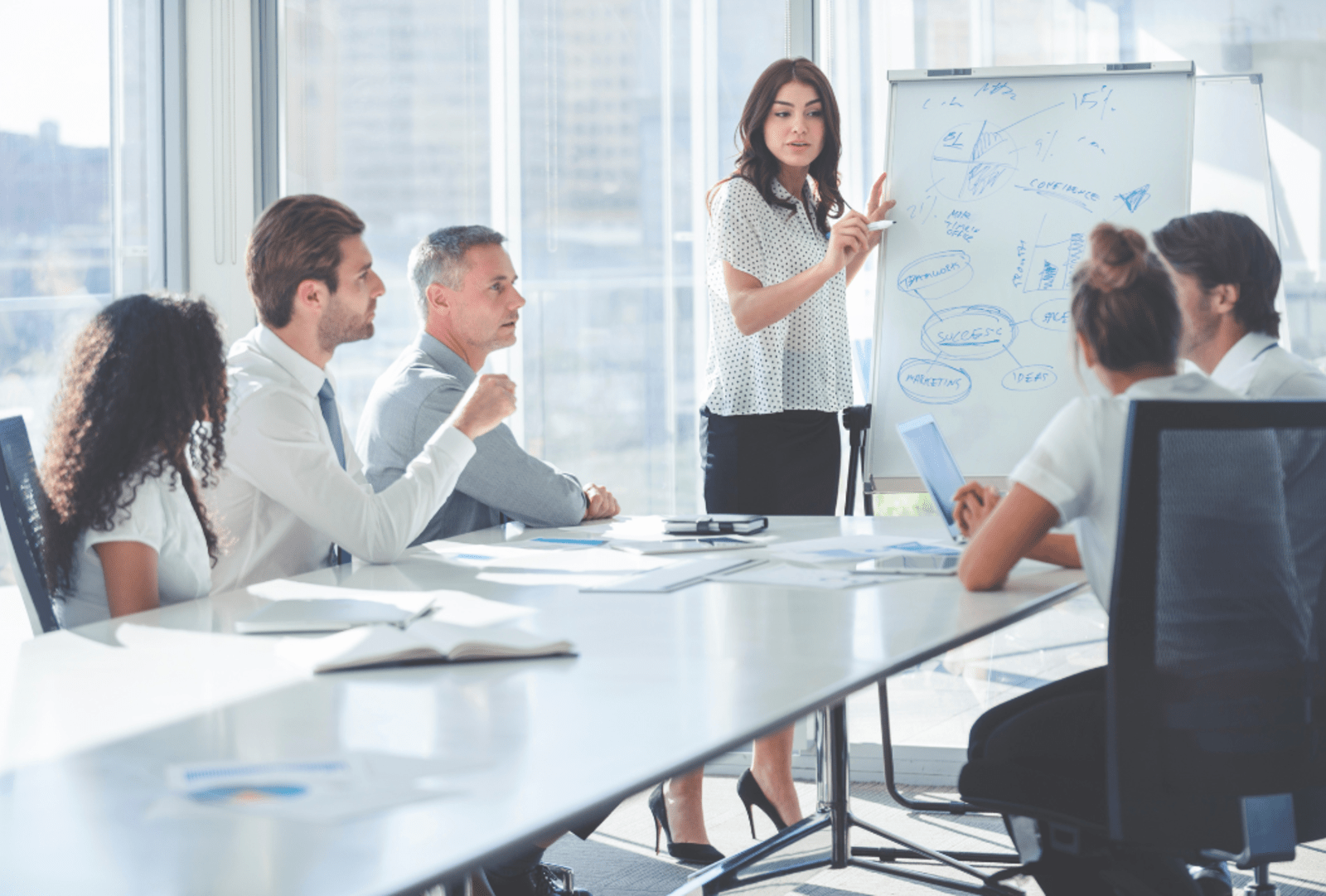Woman giving a presentation to her team.