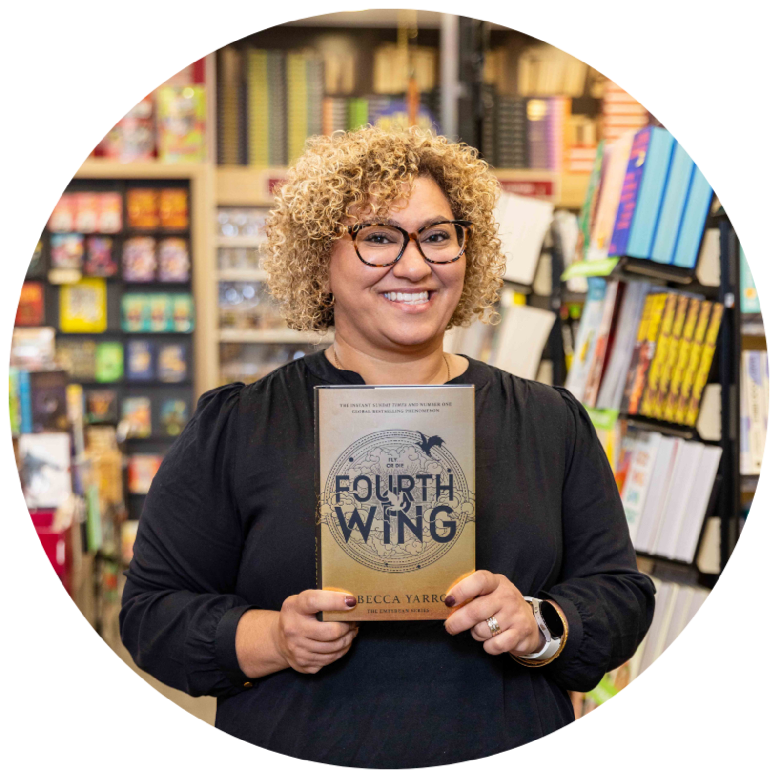 An employee of QBD Central Coast Bookstore holds her favourite book