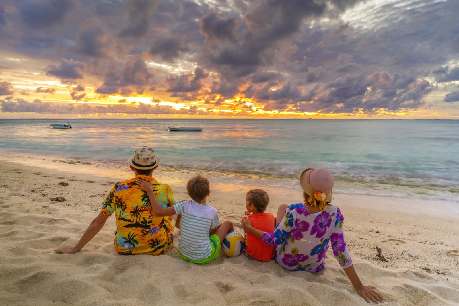 family on beach at sunset