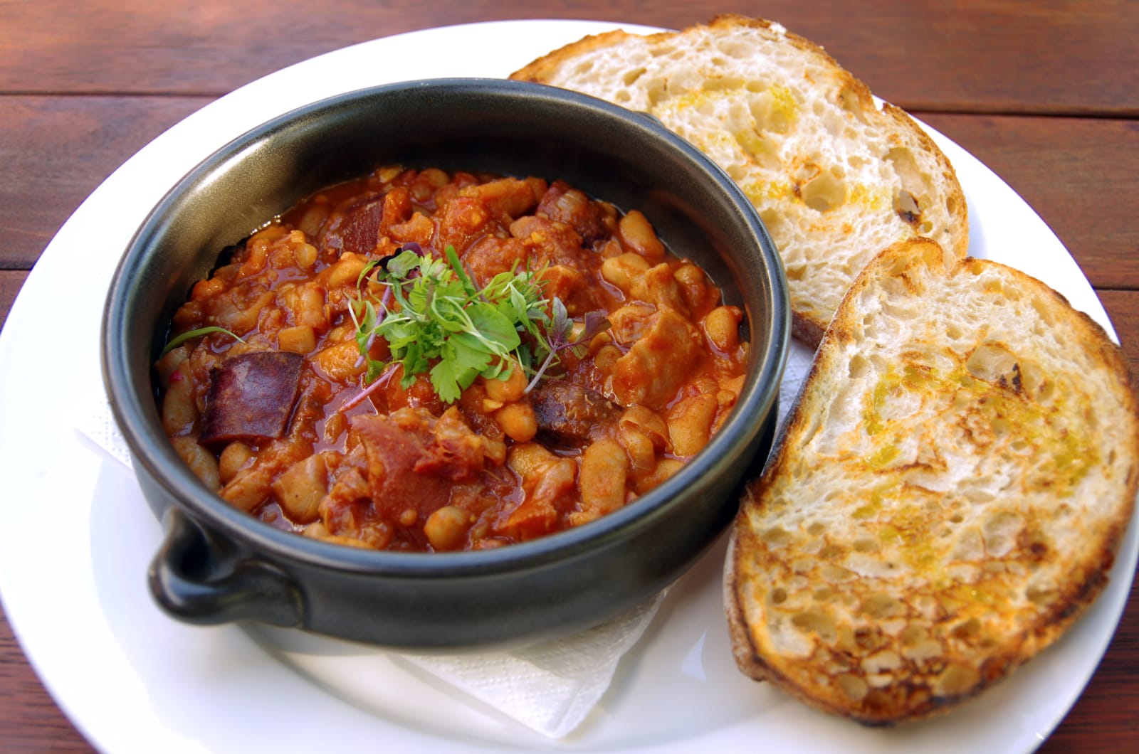 Boston baked beans with smoked ham hock, chorizo and chilli served with toasted sourdough bread