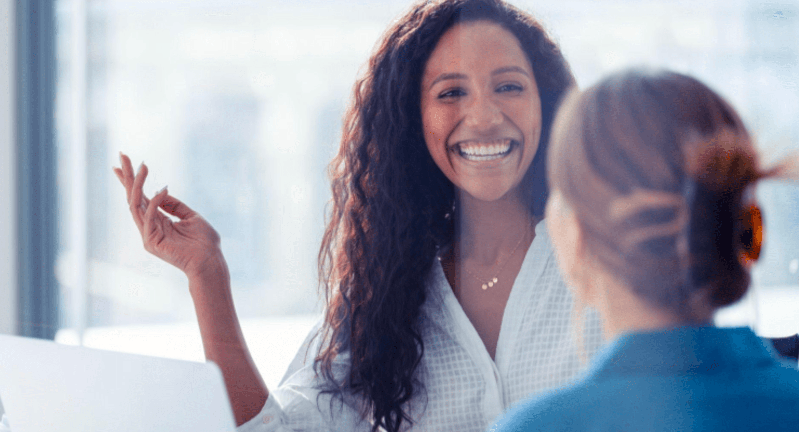 Businesswoman smiling and presenting a slide 
