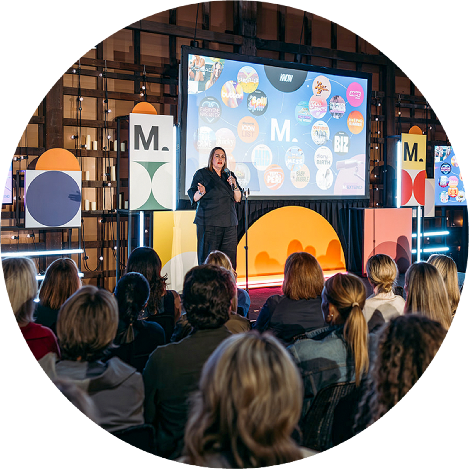 Woman with a microphone presenting a powerpoint