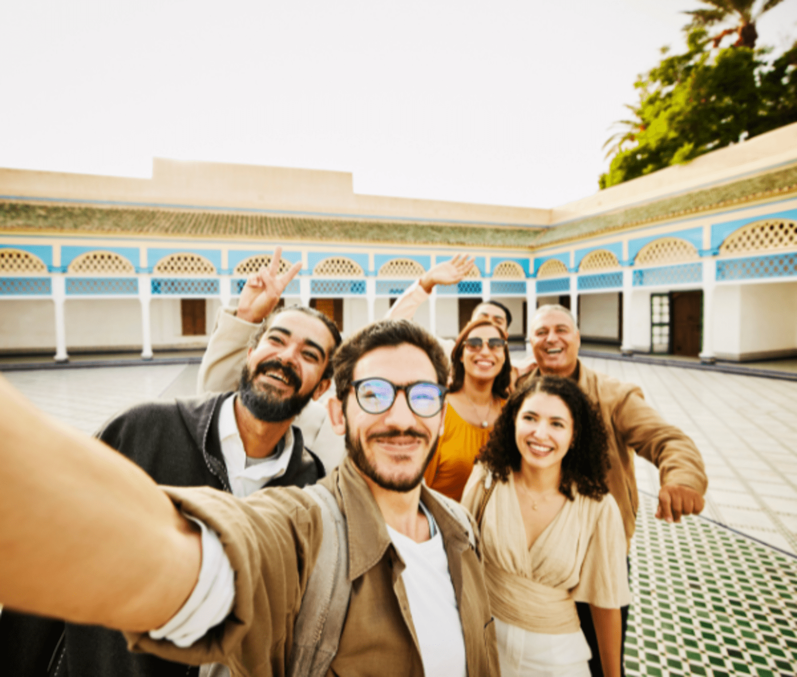 A family smiles while taking a selfie