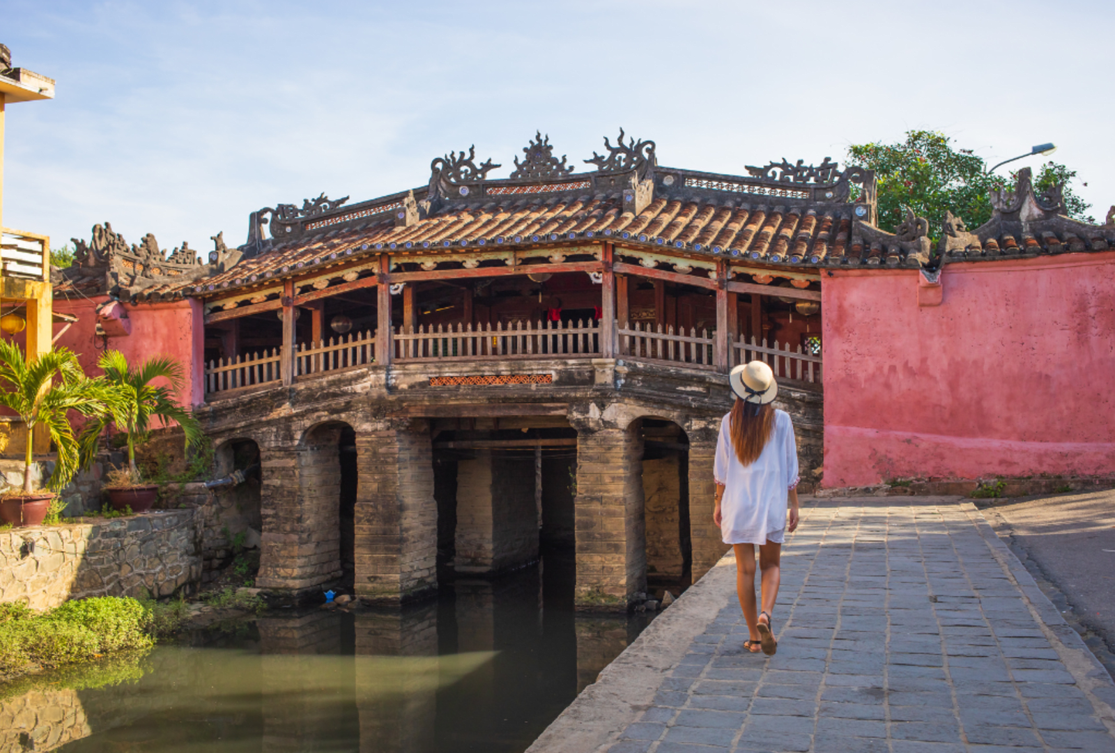 Woman walking in the old town district of Hoi An in Vietnam during a sunny day