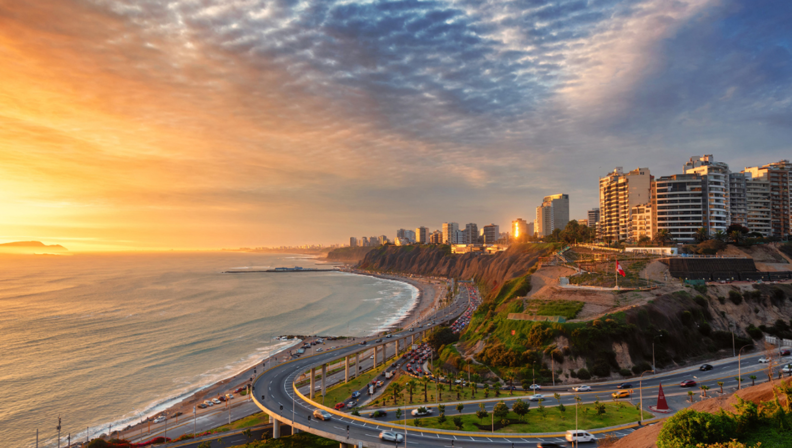 Golden hour sunset with a road lining the coast of peru