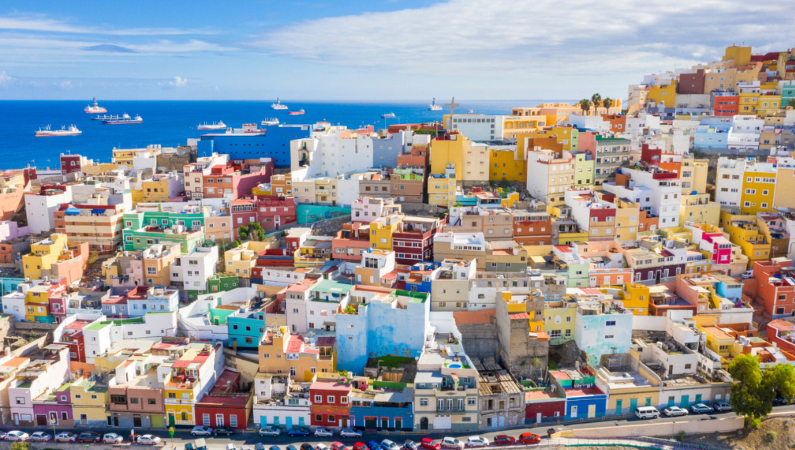 Hill full of colourful block buildings with the ocean in the background