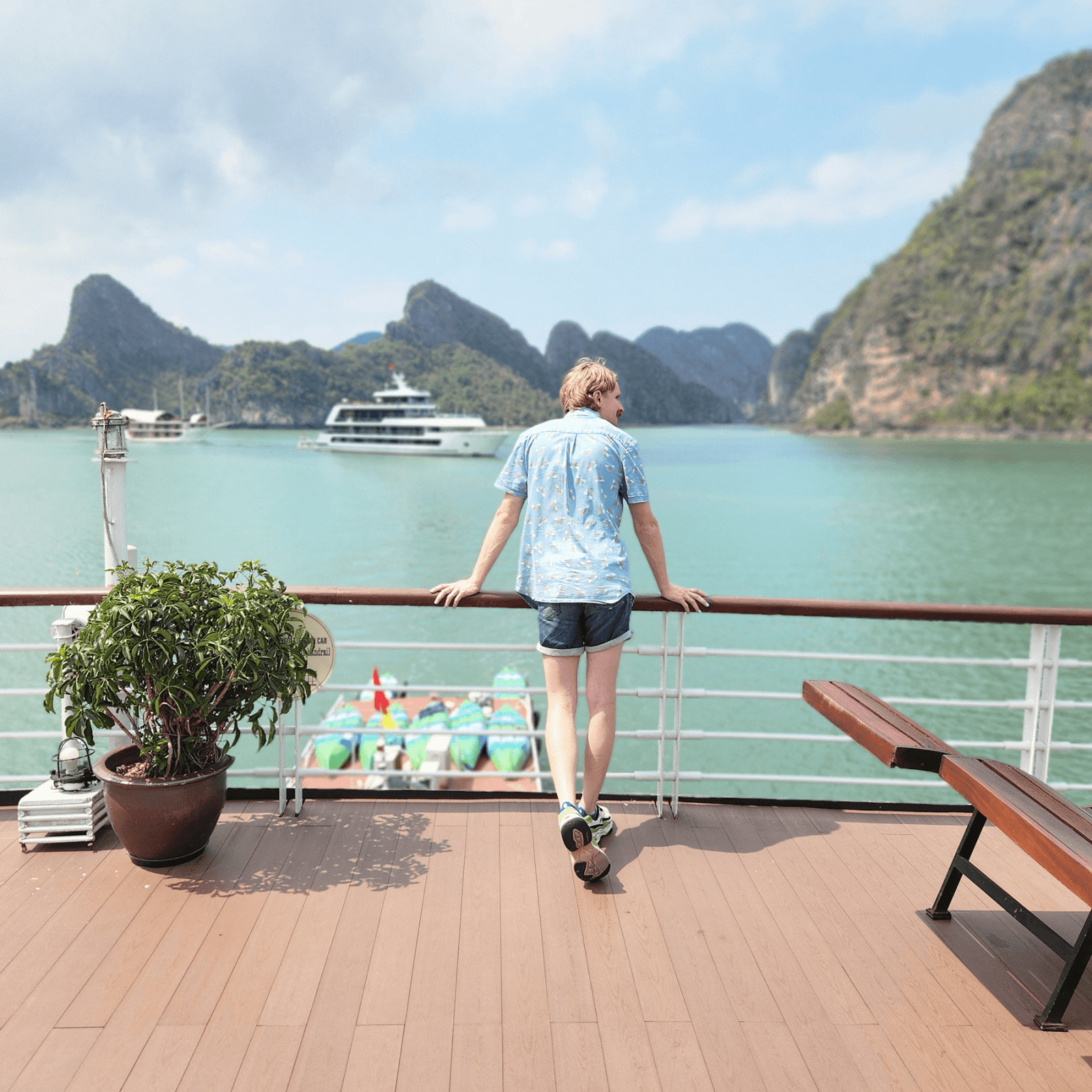 Man on a cruise ship looking out at Ha Long Bay, Vietnam