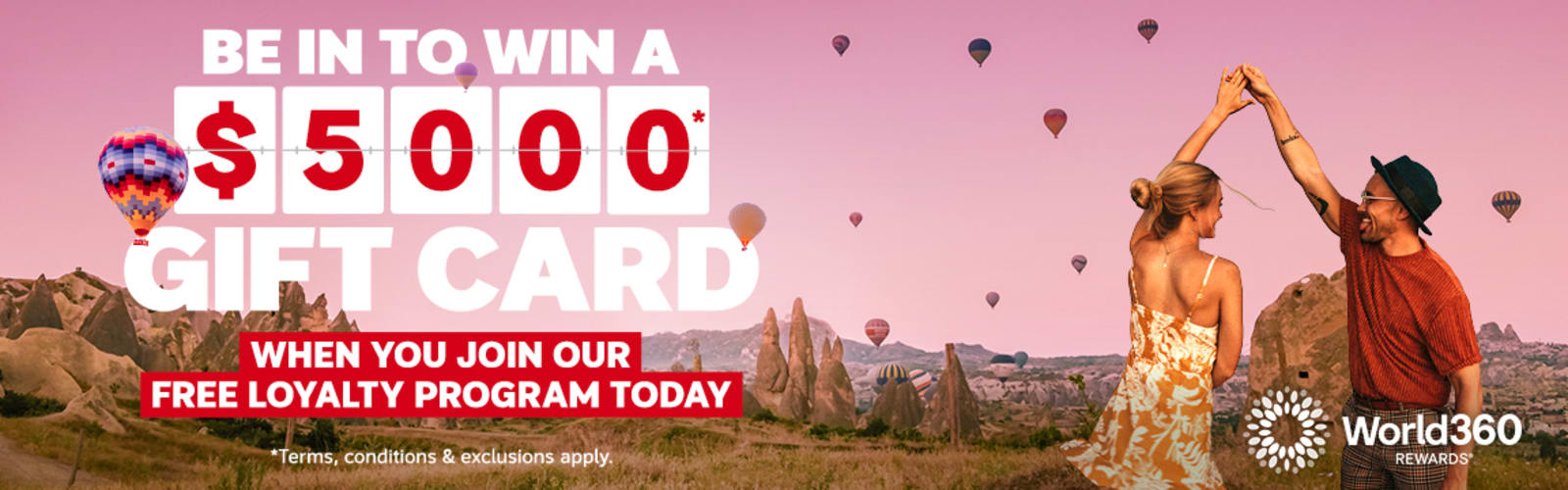 Couple dancing beneath hot air balloons over a scenic valley featuring a chance to win a $5000 gift card when you join our free loyalty program