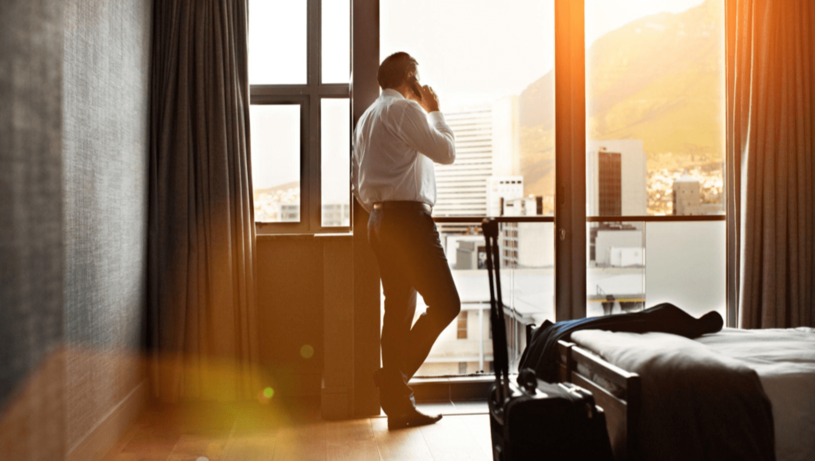 Corporate Businessman On Phone In Hotel